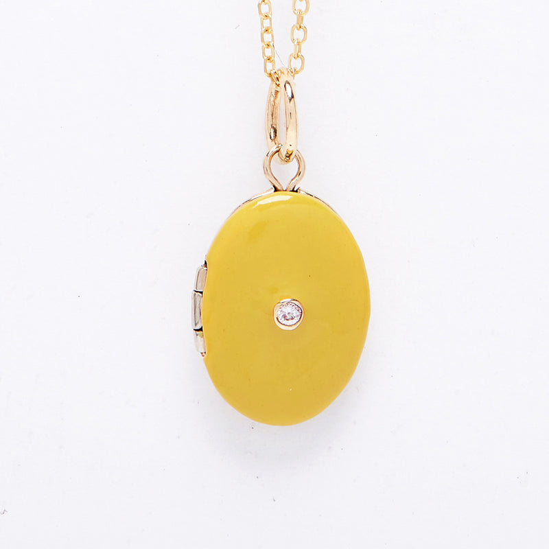 Enamel Locket with a diamond in the center sold on an 18" chain.
