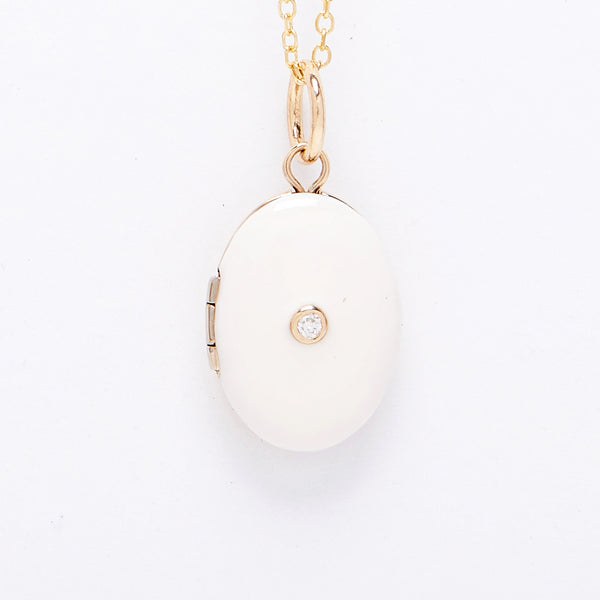 Enamel Locket with a diamond in the center sold on an 18" chain.